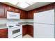 Functional kitchen with white appliances, plenty of cabinet storage, and tile backsplash at 1212 Bass Dr # C, Henderson, NV 89014