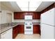 Cozy kitchen with white appliances and wood cabinets providing ample storage at 1212 Bass Dr # C, Henderson, NV 89014