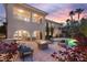 The backyard has a pool, spa, seating area with a fire pit, and manicured landscaping at 1212 Muscato Ct, Las Vegas, NV 89144