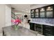 Elegant dining area with a modern bar and wine fridge, perfect for entertaining guests in style at 1212 Muscato Ct, Las Vegas, NV 89144