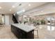 Spacious area showcases open layout from a modern kitchen island to the living room and patio at 1212 Muscato Ct, Las Vegas, NV 89144