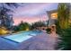 Backyard pool features a spa and waterfall feature amid mature landscaping at 1212 Muscato Ct, Las Vegas, NV 89144