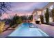 Backyard pool features a spa and waterfall feature amid mature landscaping at 1212 Muscato Ct, Las Vegas, NV 89144