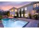 Backyard oasis with a sparkling pool, spa, covered patio, and lush landscaping at 1212 Muscato Ct, Las Vegas, NV 89144