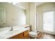 Clean bathroom featuring wood look flooring, sink with vanity, toilet, and glass shower at 1304 Husson Ct, Las Vegas, NV 89142