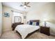 Comfortable bedroom with soft carpet, a ceiling fan, and a dresser with mirror at 1304 Husson Ct, Las Vegas, NV 89142