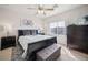Bedroom with a ceiling fan, a large window, and dark wood furniture for optimal comfort at 1304 Husson Ct, Las Vegas, NV 89142