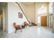 Bright foyer with a soaring ceiling, tile flooring, staircase, and light fixture at 1304 Husson Ct, Las Vegas, NV 89142