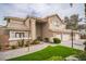 Charming two-story home with a well-manicured lawn and a spacious three-car garage at 1304 Husson Ct, Las Vegas, NV 89142