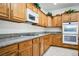 Well-lit kitchen with wood cabinets, granite countertops, gas range, and double wall oven at 1304 Husson Ct, Las Vegas, NV 89142