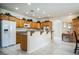 Bright kitchen features wood cabinets, granite counters, a breakfast bar and stainless steel appliances at 1304 Husson Ct, Las Vegas, NV 89142