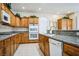 Spacious kitchen with granite countertops, tile floors, and wooden cabinetry featuring modern appliances at 1304 Husson Ct, Las Vegas, NV 89142