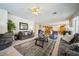 Open-concept living room with a fireplace, plush sofas, and seamless access to the dining area at 1304 Husson Ct, Las Vegas, NV 89142