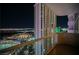 Balcony view overlooking Topgolf Las Vegas and the cityscape at night, with a high-rise building in the foreground at 135 Harmon Ave # 3220, Las Vegas, NV 89109