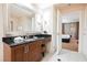 Well-lit bathroom boasts a dark granite countertop, a large mirror and direct access to the bedroom at 135 Harmon Ave # 3220, Las Vegas, NV 89109