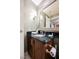 Well-lit bathroom featuring a granite countertop, vanity with drawers and a decorative mirror at 135 Harmon Ave # 3220, Las Vegas, NV 89109