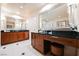 Bathroom featuring double sink vanity, stool and large mirrors at 135 Harmon Ave # 3220, Las Vegas, NV 89109