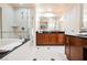 Bathroom featuring spacious vanity, large mirror, soaking tub, and glass enclosed walk-in shower at 135 Harmon Ave # 3220, Las Vegas, NV 89109
