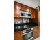 Modern kitchen featuring stainless steel appliances, dark countertops, and wooden cabinets at 135 Harmon Ave # 3220, Las Vegas, NV 89109