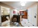 Open-concept kitchen with bar seating, stainless steel appliances, and adjacent bathroom at 135 Harmon Ave # 3220, Las Vegas, NV 89109