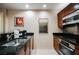 Modern kitchen with stainless steel sink, black countertop, appliances, and ample cabinet space at 135 Harmon Ave # 3220, Las Vegas, NV 89109