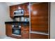 Close-up on stainless steel oven and refrigerator, accented by black countertops at 135 Harmon Ave # 3220, Las Vegas, NV 89109