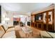 Open living area with kitchen view, dining table, comfortable seating, and built-in tv cabinet at 135 Harmon Ave # 3220, Las Vegas, NV 89109