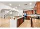 Open-concept kitchen with granite countertops, stainless steel appliances, and a view of the living room at 1640 Orange Daisy Pl, Henderson, NV 89012