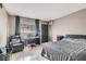 Bedroom with a large bed, comfortable chair, and work area with an air conditioner at 1701 Linden Ave, Las Vegas, NV 89101