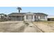 Charming single-story home featuring a spacious front yard and a unique horizontally slatted privacy enclosure at 1701 Linden Ave, Las Vegas, NV 89101