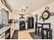 Modern kitchen featuring sleek black appliances, white cabinetry, and a cozy dining area at 1701 Linden Ave, Las Vegas, NV 89101