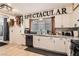 Bright kitchen featuring white cabinets, stainless appliances, and wood-style flooring at 1701 Linden Ave, Las Vegas, NV 89101