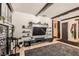 Inviting living room showcasing a TV, decorative shelves, and a stone fireplace for a comfortable ambiance at 1701 Linden Ave, Las Vegas, NV 89101