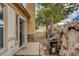 Desert landscaping backyard with privacy wall, barbecue and small patio area at 228 Lorryn Ln # 2, Boulder City, NV 89005
