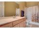 Neutral bathroom featuring wood cabinets, cultured marble countertop and shower-tub combination at 228 Lorryn Ln # 2, Boulder City, NV 89005