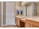 Bright bathroom featuring double sinks, tile flooring, and neutral paint colors at 228 Lorryn Ln # 2, Boulder City, NV 89005