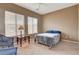 Cozy bedroom with plush carpet, two windows with blinds, and a ceiling fan at 228 Lorryn Ln # 2, Boulder City, NV 89005