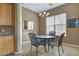 Cozy dining area featuring neutral colors, tile flooring, and modern chandelier lighting at 228 Lorryn Ln # 2, Boulder City, NV 89005