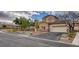 Inviting two-story home featuring desert landscaping, a two-car garage, and ample parking at 228 Lorryn Ln # 2, Boulder City, NV 89005