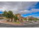 Exterior view of a home showcasing landscape, three mature trees and large driveway at 228 Lorryn Ln # 2, Boulder City, NV 89005