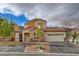 Inviting front home exterior with well-manicured landscaping and a two-car garage at 228 Lorryn Ln # 2, Boulder City, NV 89005