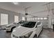 Spacious two-car garage with white walls, window for natural light, and two white cars parked inside at 228 Lorryn Ln # 2, Boulder City, NV 89005