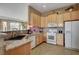 Well-lit kitchen with granite countertops and modern appliances at 228 Lorryn Ln # 2, Boulder City, NV 89005