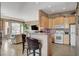 Kitchenette with bar seating, adjacent to a living room at 228 Lorryn Ln # 2, Boulder City, NV 89005