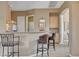 Kitchenette area features bar seating, upper and lower cabinets, and neutral colors at 228 Lorryn Ln # 2, Boulder City, NV 89005