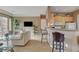 Cozy living room featuring tile floors, a breakfast bar, and neutral paint colors at 228 Lorryn Ln # 2, Boulder City, NV 89005