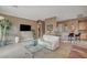Spacious living area with large tile, TV, and bar seating at 228 Lorryn Ln # 2, Boulder City, NV 89005