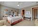 Spacious main bedroom features tray ceilings, neutral paint, bench seat, and tile flooring at 228 Lorryn Ln # 2, Boulder City, NV 89005