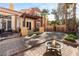 Inviting backyard with patio, pergola, fire pit, and lush landscaping, perfect for outdoor entertaining at 23 Cerchio Basso, Henderson, NV 89011