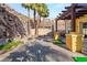 Charming backyard with a stone wall, pergola, and a cozy seating area around a fire pit at 23 Cerchio Basso, Henderson, NV 89011